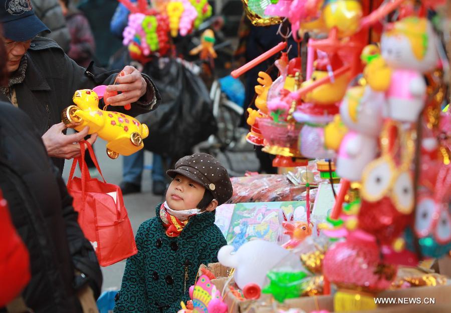 A father chooses a lantern for his child at a market in Shanghai, east China, Feb. 20, 2013. An annual lantern sales boom appeared with the approaching of the Lantern Festival which falls on Feb. 24 this year. (Xinhua/Pei Xin) 