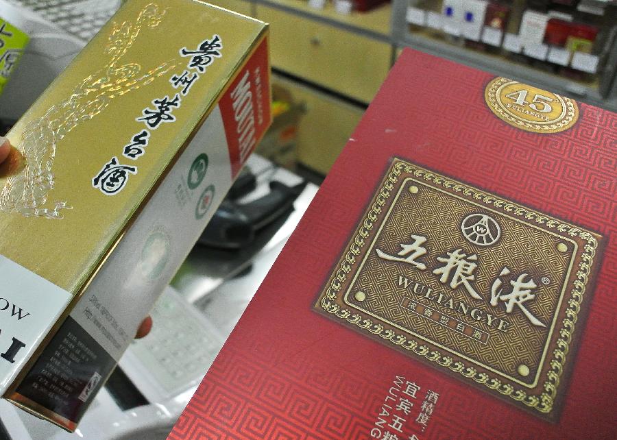 Photo taken on Feb. 19, 2013 shows Kweichow Moutai Liquor and Wuliangye Liquor at a supermarket in Beijing, capital of China. Two Chinese liquor makers, Kweichow Moutai Co. Ltd and Wuliangye Yibin Co. Ltd, have been fined 449 million yuan, equivalent to 1 percent of all sales of the two companies throughout 2012, for their involvement in price monopoly activity. (Xinhua/Li Fangyu)