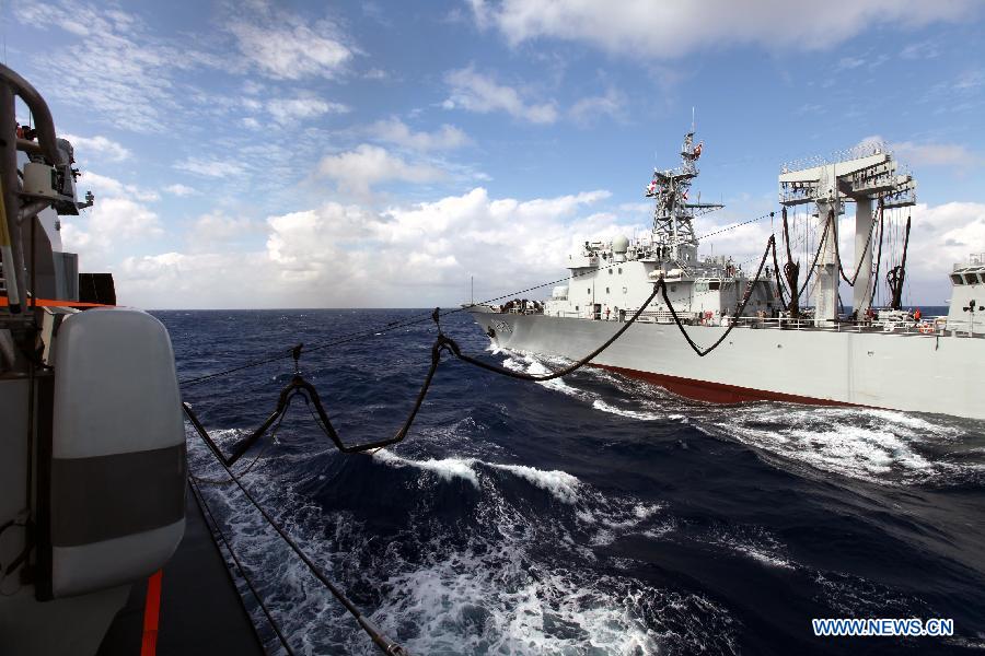 Supply ship Weishanhu (R) tranport fuel and other materials to Missile destroyer Harbin at the South China Sea, Feb. 20, 2013. The supply ship Weishanhu reinforced the missile destroyer Harbin and the frigate Mianyang on Wednesday with fuel, fresh water and other materials. The 14th naval squad, sent by the Chinese People's Liberation Army (PLA) Navy, departed Saturday from China to the Gulf of Aden and Somali waters for escort missions. The fleet comprises three ships -- the missile destroyer Harbin, the frigate Mianyang and the supply ship Weishanhu -- carrying two helicopters and a 730-strong troop. (Xinhua/Rao Rao)