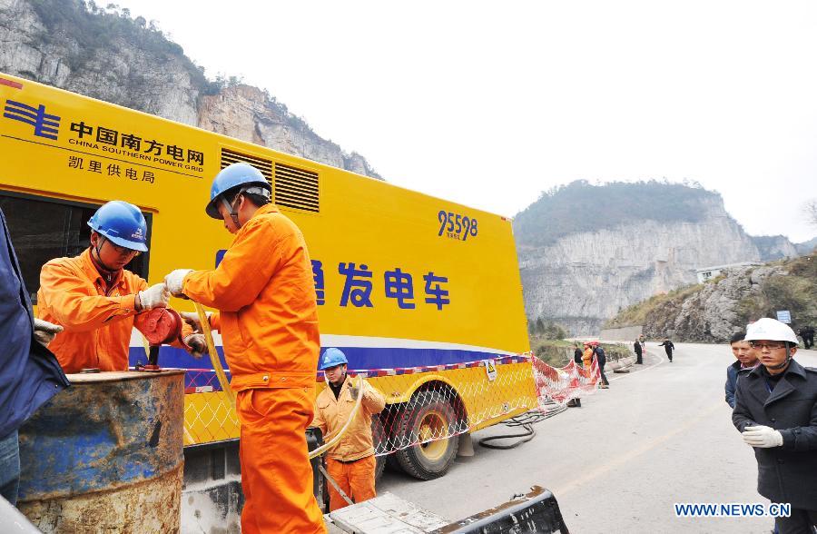 Workers of power supply bureau refuel the emergency generator truck at a landslide site in Longchang Township, Kaili City, southwest China's Guizhou Province, Feb. 20, 2013. Five coal mine workers and their relatives, including two children, are believed to have been buried by a landslide which occurred around 11 a.m. here on Feb. 18. Rocks have blocked a nearby river with a rising water level, forming a barrier lake. The water level has decreased for 1.5 meters as of 5:00 p.m. Wednesday. (Xinhua/Yao Yao) 