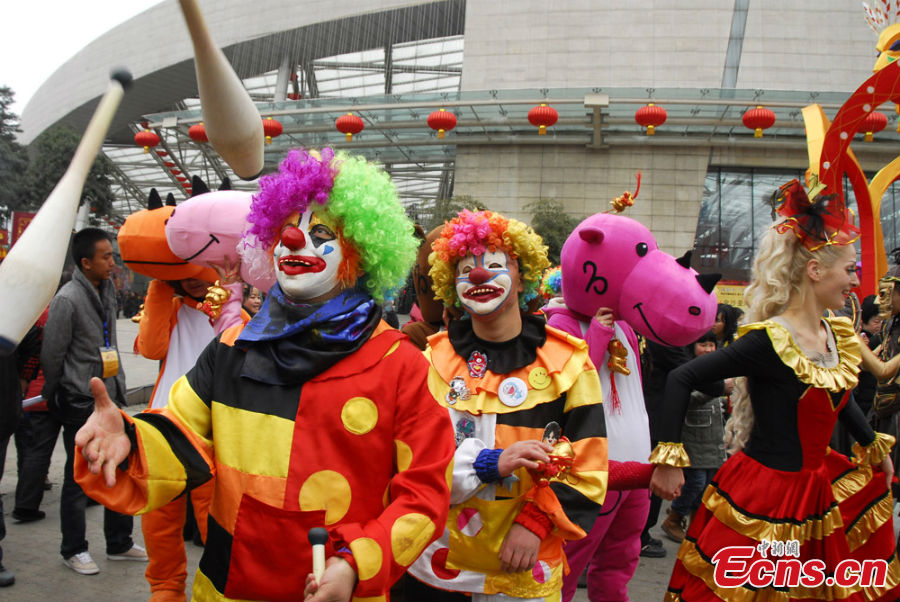 People in colorful costumes participate in a parade held to celebrate the Jinsha Sun Festival in Jinsha Village, Chengdu, Southwest China's Sichuan Province, February 20, 2013. Jinsha Village is home to the Jinsha Relics Museum, which, located at the Jinsha Archeological Site, is a theme park-style museum for the protection of, research into and display of Jinsha relics and archaeological finds. (CNS/Jin Sha)