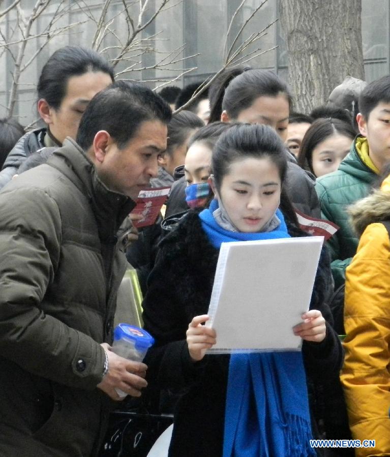Examinees wait to sign up for the entrance examination of the Beijing Film Academy (BFA) in Beijing, capital of China, Feb. 21, 2013. BFA is one of China's leading bases of movie education, where many movie celebrities like director Zhang Yimou and numerous actors graduated. With the dreams to become future movie stars, thousands of young people cram to BFA for the enrollment exam every year. (Xinhua/Wang Zhen)