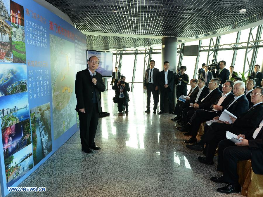 Wu Bangguo (3rd R, front), chairman of the National People's Congress (NPC) Standing Committee, listens to the introduction on the city planning in Macao Tower in Macao, south China, Feb. 21, 2013. Wu is in Macao to attend celebrations of the 20th anniversary of the promulgation of the Basic Law of the Macao Special Administrative Region. (Xinhua/Ma Zhancheng) 