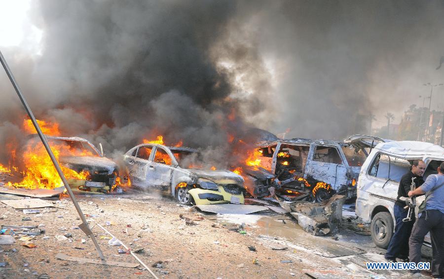 A handout picture released by the official Syrian Arab News Agency (SANA) shows burning cars after a blast in Damascus, Syria, Feb. 21, 2013. A big blast rocked a busy intersection in the capital Damascus Thursday close to the ruling al-Baath party headquarters, leaving unspecified number of casualties, witnesses and reports said. (Xinhua/SANA)