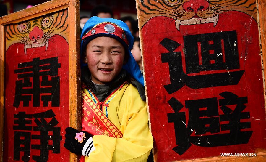 A young performer takes part in a Shehuo parade in Huangzhong County, northwest China's Qinghai province, Feb. 21, 2013. The performance of Shehuo can be traced back to ancient rituals to worship the earth, which they believe could bring good harvests and fortunes in return. Most Shehuo performances take place around traditional Chinese festivals, especially the Spring Festival and the Lantern Festival. (Xinhua/Zhang Hongxiang) 