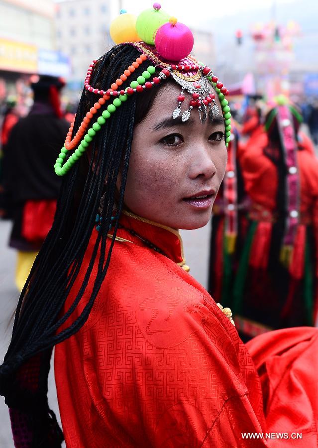 A Tibetan performer prepares for a Shehuo parade in Huangzhong County, northwest China's Qinghai province, Feb. 21, 2013. The performance of Shehuo can be traced back to ancient rituals to worship the earth, which they believe could bring good harvests and fortunes in return. Most Shehuo performances take place around traditional Chinese festivals, especially the Spring Festival and the Lantern Festival. (Xinhua/Zhang Hongxiang) 