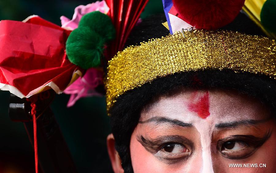 A young performer takes part in a Shehuo parade in Huangzhong County, northwest China's Qinghai province, Feb. 21, 2013. The performance of Shehuo can be traced back to ancient rituals to worship the earth, which they believe could bring good harvests and fortunes in return. Most Shehuo performances take place around traditional Chinese festivals, especially the Spring Festival and the Lantern Festival. (Xinhua/Zhang Hongxiang) 