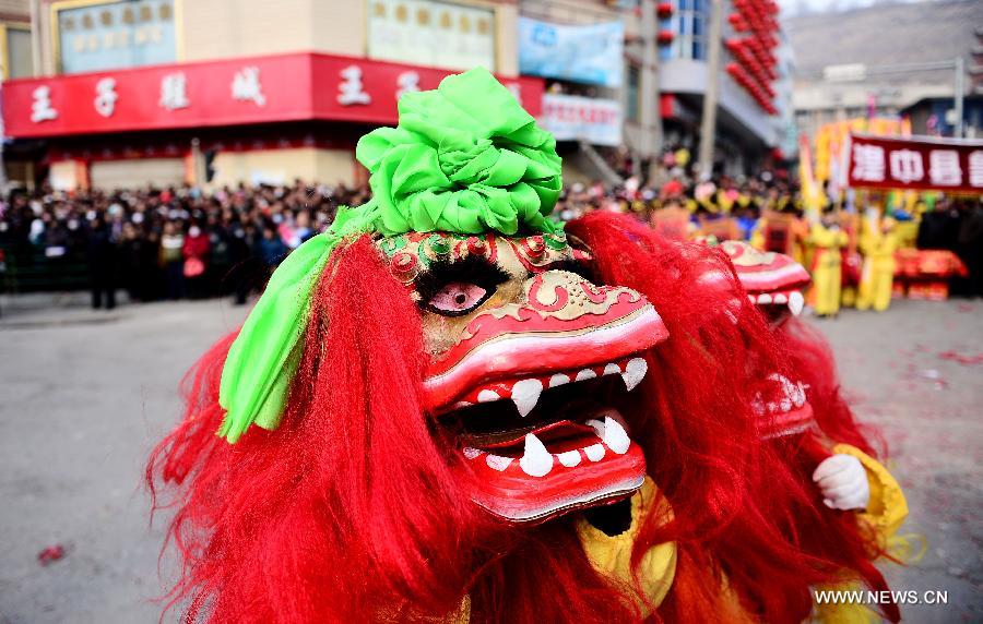 Performers play lion dance during a Shehuo parade in Huangzhong County, northwest China's Qinghai province, Feb. 21, 2013. The performance of Shehuo can be traced back to ancient rituals to worship the earth, which they believe could bring good harvests and fortunes in return. Most Shehuo performances take place around traditional Chinese festivals, especially the Spring Festival and the Lantern Festival. (Xinhua/Zhang Hongxiang) 