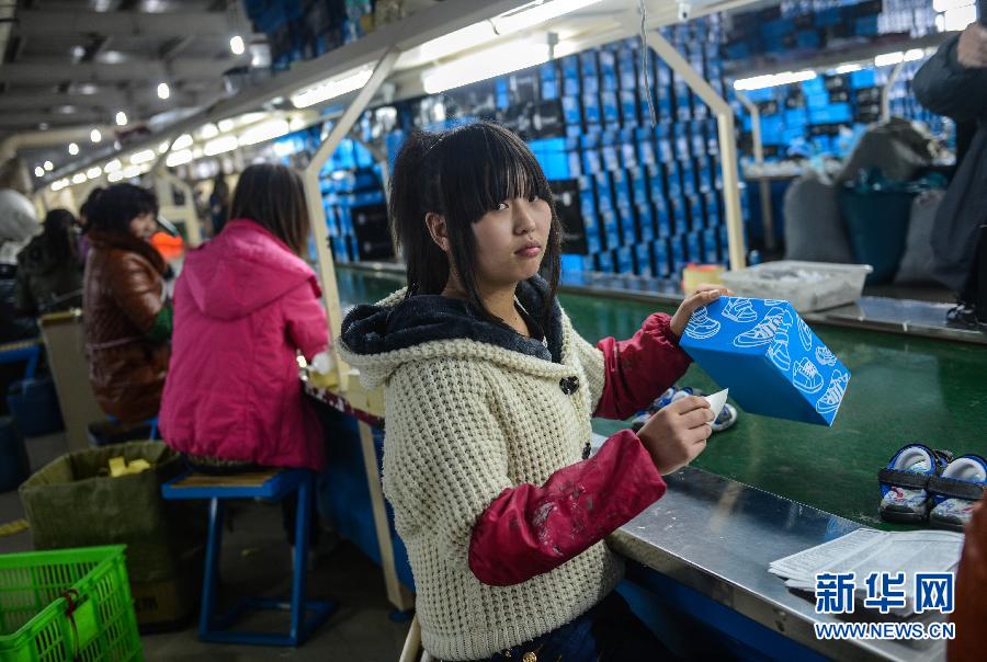 Jia Xiangfeng, 18, is from Zhaotong, Yunnan. She works for a shoes packing factory as an intern, and hope the factory will hire her after internship. Photo taken on Feb. 17, 2013. (Xinhua/ Han Chuanhao)