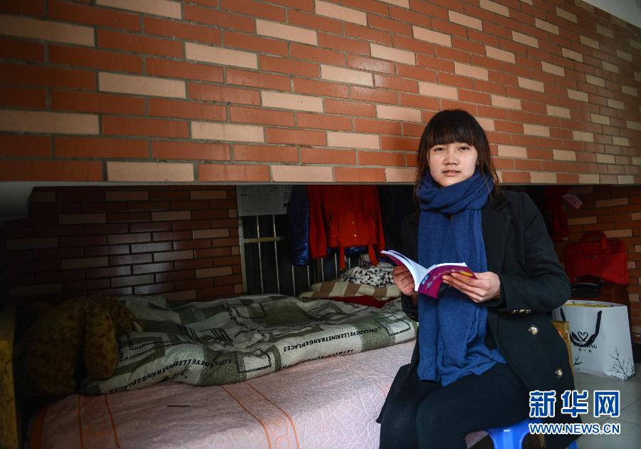 Mei Huaiyuan sits in a room smaller than 10 square meters she rent for 200 yuan per month on Feb. 19, 2013. Mei Huaiyuan was born in 1992, and left hometown for work before graduating from high school. She is a sales clerk in a health product company in Mengshan, Zhejiang. She loves readings in spare time. She hopes she will settle down in Hangzhou if her financial condition permits. (Xinhua/ Han Chuanhao)