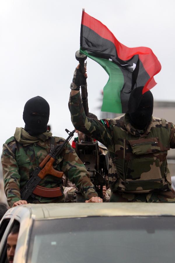Libyan soldiers demonstrate their skills during a military parade for the second anniversary of a political upheaval that toppled former leader Muammar Gaddafi in the Libyan capital Tripoli, on Feb. 21, 2013 (Xinhua/Hamza Turkia) 