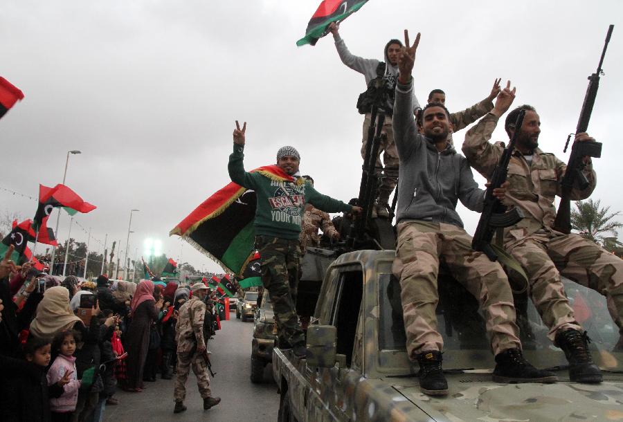 Libyan soldiers demonstrate their skills during a military parade for the second anniversary of a political upheaval that toppled former leader Muammar Gaddafi in the Libyan capital Tripoli, on Feb. 21, 2013 (Xinhua/Hamza Turkia) 