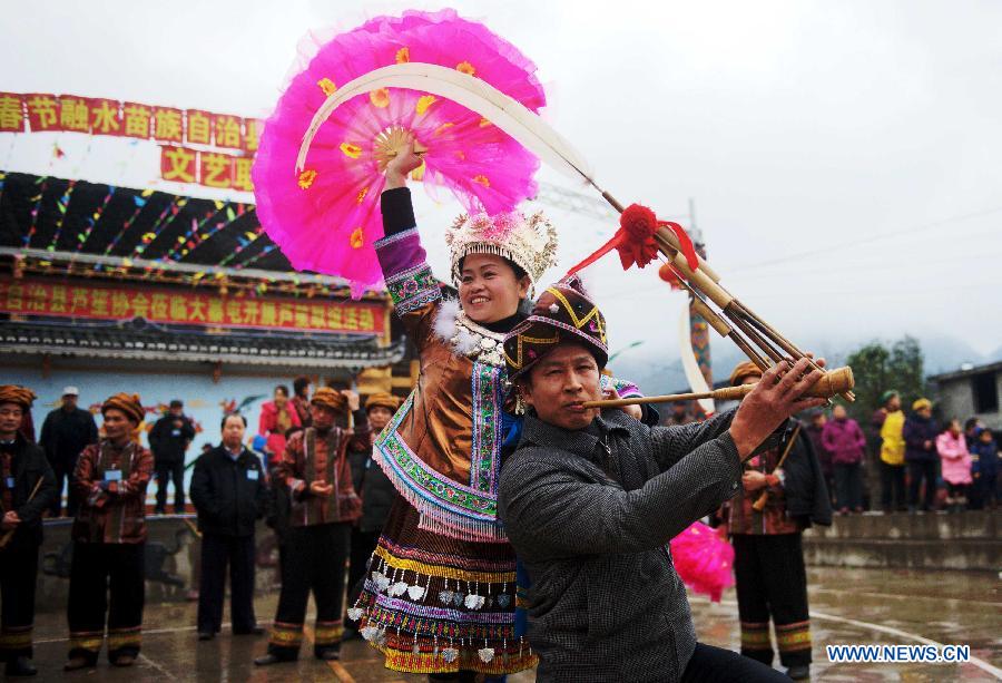 Locals of Miao ethnic group play Lusheng (a reed-pipe wind instrument) dance during a traditional gathering between villages to mark the Spring Festival, or Chinese Lunar New Year, at Antai Township in Rongshui Miao Autonomous County, south China's Guangxi Zhuang Autonomous Region, Feb. 21, 2013. (Xinhua/Zhang Ailin) 