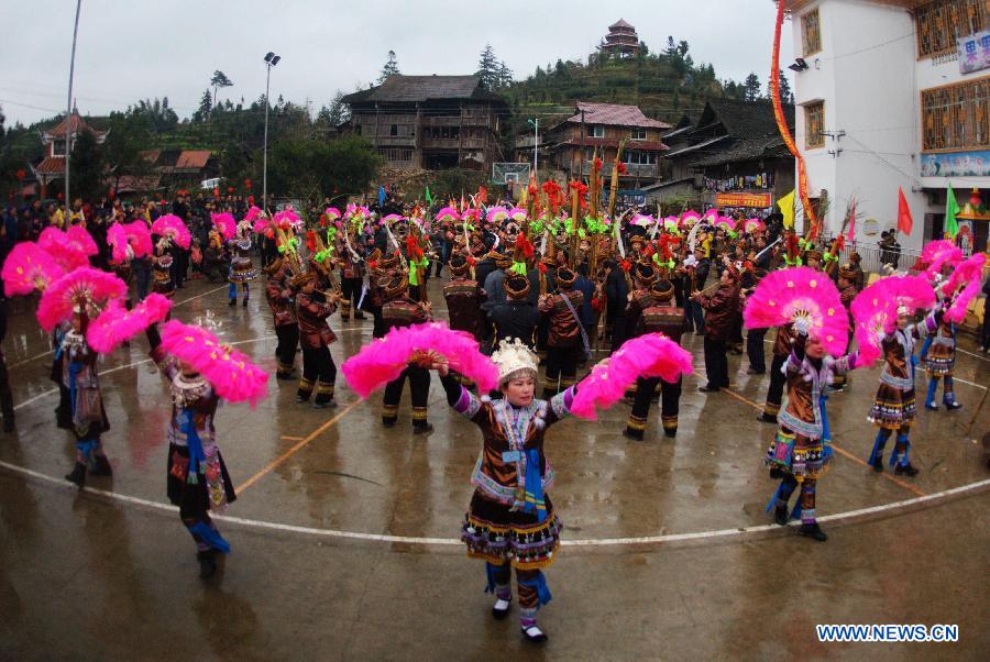 Locals of Miao ethnic group play Lusheng (a reed-pipe wind instrument) dance during a traditional gathering between villages to mark the Spring Festival, or Chinese Lunar New Year, at Antai Township in Rongshui Miao Autonomous County, south China's Guangxi Zhuang Autonomous Region, Feb. 21, 2013. (Xinhua/Zhang Ailin) 