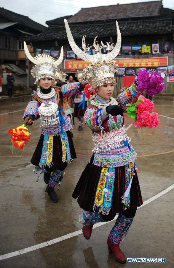 Fully-dressed girls of Miao ethnic group dance during a traditional gathering between villages to mark the Spring Festival, or Chinese Lunar New Year, at Antai Township in Rongshui Miao Autonomous County, south China's Guangxi Zhuang Autonomous Region, Feb. 21, 2013. (Xinhua/Zhang Ailin)     1 2 3 4 5 6 7 8   