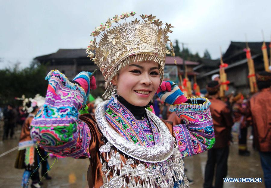 A fully-dressed girl of Miao ethnic group dances during a traditional gathering between villages to mark the Spring Festival, or Chinese Lunar New Year, at Antai Township in Rongshui Miao Autonomous County, south China's Guangxi Zhuang Autonomous Region, Feb. 21, 2013. (Xinhua/Zhang Ailin) 