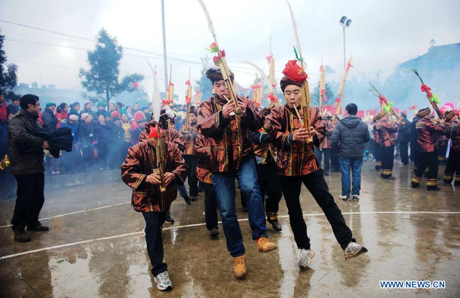 Young men of Miao ethnic group play Lusheng (a reed-pipe wind instrument) during a traditional gathering between villages to mark the Spring Festival, or Chinese Lunar New Year, at Antai Township in Rongshui Miao Autonomous County, south China's Guangxi Zhuang Autonomous Region, Feb. 21, 2013. (Xinhua/Zhang Ailin) 