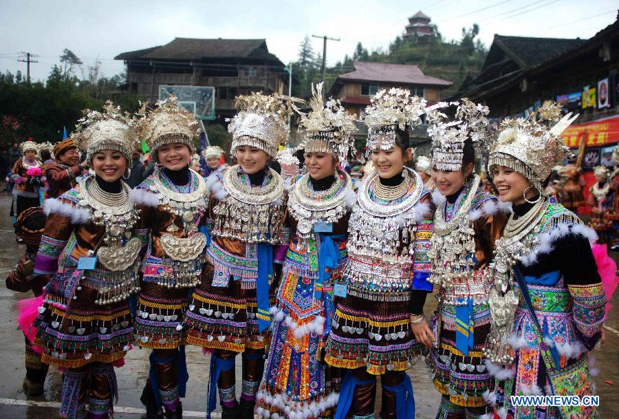 Fully-dressed girls of Miao ethnic group pose for a photo during a traditional gathering between villages to mark the Spring Festival, or Chinese Lunar New Year, at Antai Township in Rongshui Miao Autonomous County, south China's Guangxi Zhuang Autonomous Region, Feb. 21, 2013. (Xinhua/Zhang Ailin) 