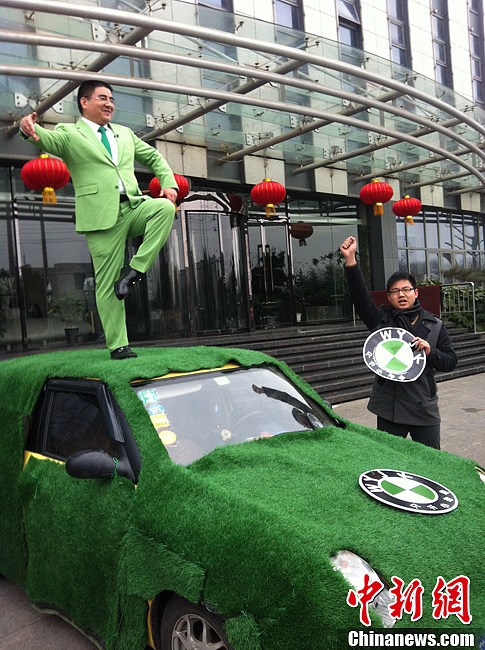 Chen Guangbiao stands on the top of a small displacement vehicle and calls people to drive small displacement cars to support environmental protection. (Chinanews/Huang Li)
