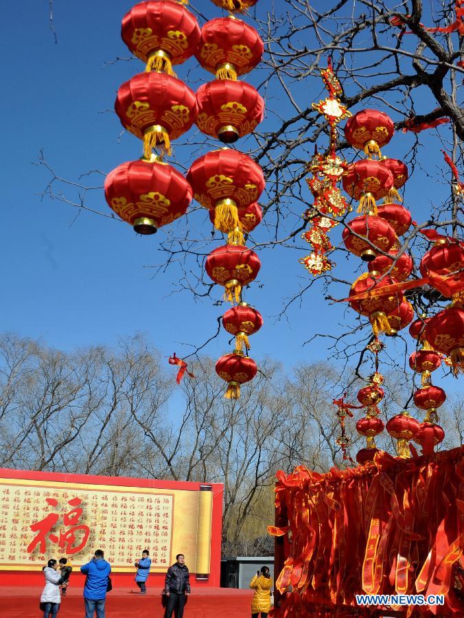 People visit the Old Summer Palace, or Yuanmingyuan, in Beijing, capital of China, Feb. 22, 2013. Thousands of red lanterns are hung at the imperial garden to greet the upcoming Lantern Festival, which falls on Feb. 24 this year. (Xinhua/Li Xin)