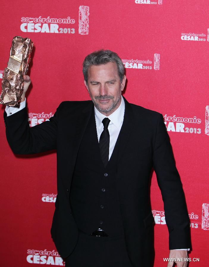 US actor Kevin Costner holds his Cesar of Honor as he poses for photos during the 38th annual Cesar awards ceremony held at the Chatelet Theatre in Paris, France, Feb. 22, 2013. (Xinhua/Gao Jing)