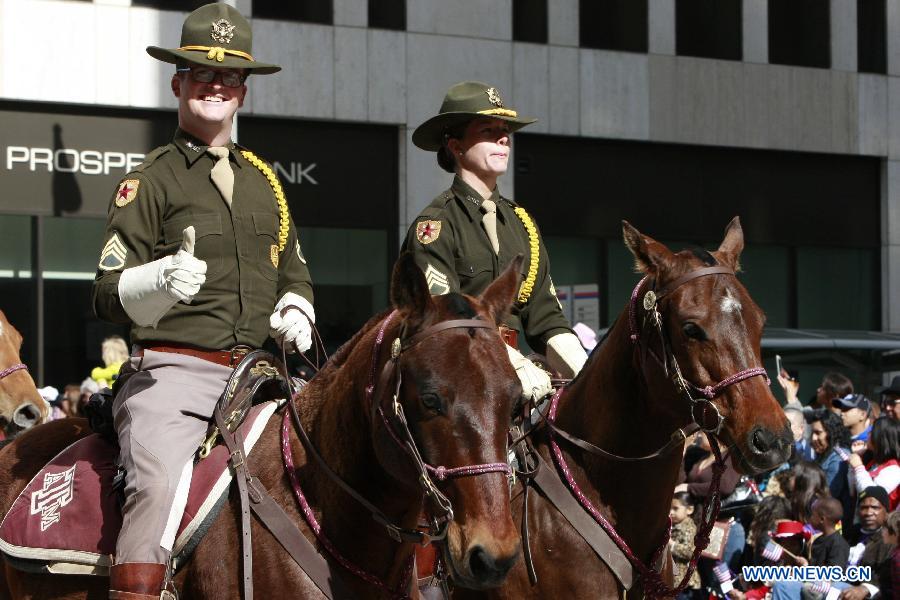 People dressed up as cowboys attend the annual Houston Rodeo parade in Houston, the United States, Feb. 23, 2013. (Xinhua/Song Qiong) 