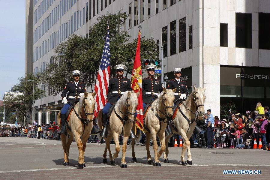 People dressed up as cowboys attend the annual Houston Rodeo parade in Houston, the United States, Feb. 23, 2013. (Xinhua/Song Qiong) 