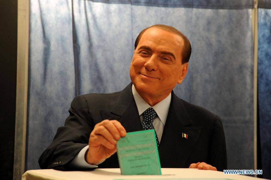 Italian ex-premier and media mogul Silvio Berlusconi casts his vote at the polling station in Milan, Italy, Feb. 24, 2013. Italians began voting for a new government Sunday, the outcome of which has had global markets and the country's European partners anxious about for weeks. (Xinhua/Angela Quattrone) 