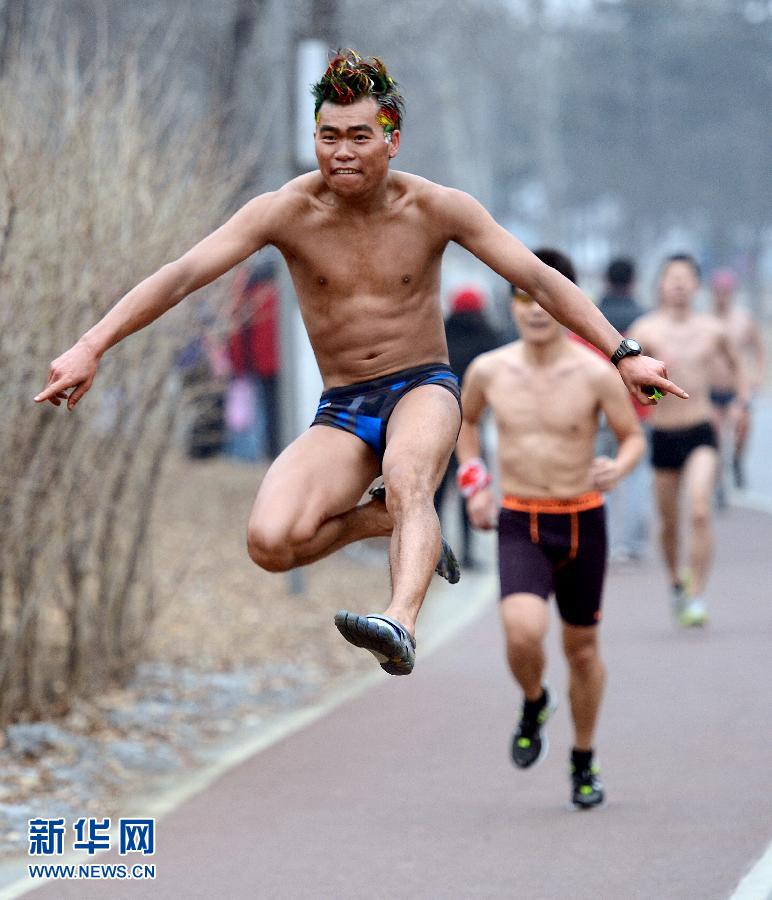 People take part in a running event promoting an environmentally friendly lifestyle at the Olympic Forest Park in Beijing on Sunday. (Xinhua/Wang Yuguo) 