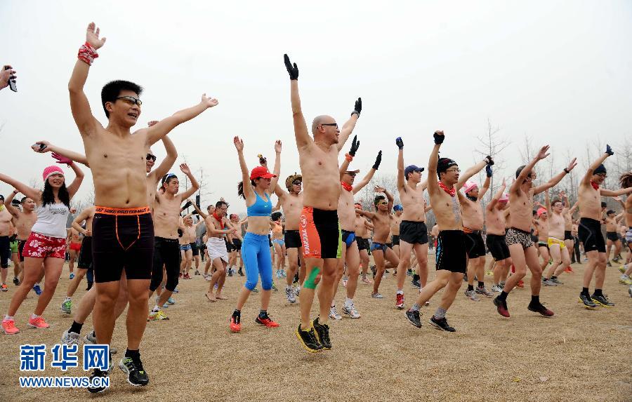 People take part in a running event promoting an environmentally friendly lifestyle at the Olympic Forest Park in Beijing on Sunday. (Xinhua/Wang Yuguo) 