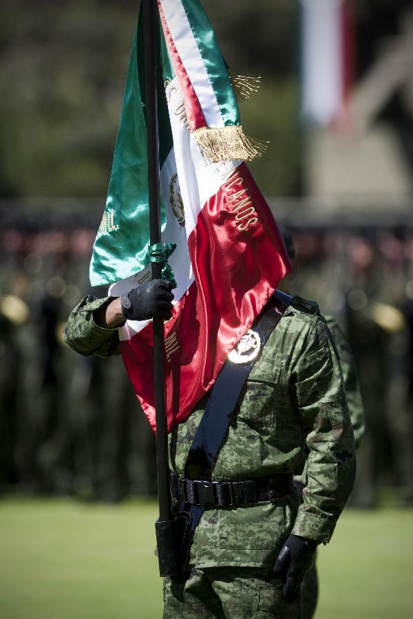 A Mexican soldier attends a ceremony to commemorate the National Flag Day held at the Marte Military Camp, in Mexico City, capital of Mexico, Feb. 24, 2013. (Xinhua/Rodrigo Oropeza) 