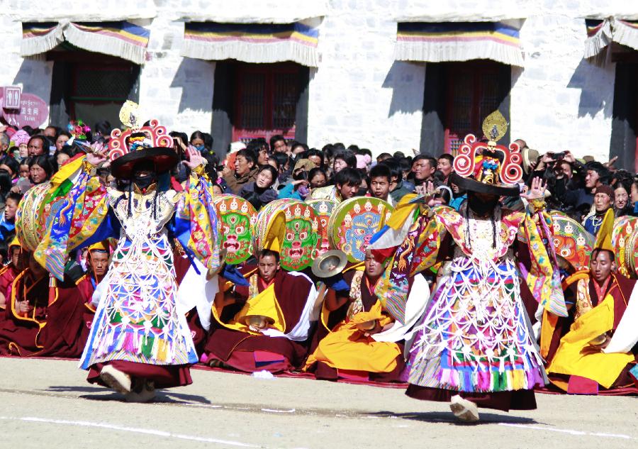 Two dancers perform a ritual dance to pray for good fortune and harvest at the Labrang Monastery in Xiahe County, Gannan Tibetan Autonomous Prefecture, northwest China's Gansu Province, Feb. 23, 2013. The Labrang Monastery is among the six great monasteries of the Geluk school of Tibetan Buddhism. (Xinhua/Shi Youdong)