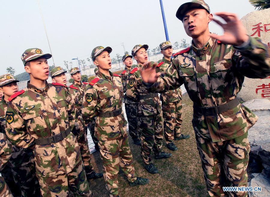 Members of Chinese People's Armed Police Force chorus during a training break in Shanghai, east China, Feb. 25, 2013. (Xinhua/Chen Fei) 
