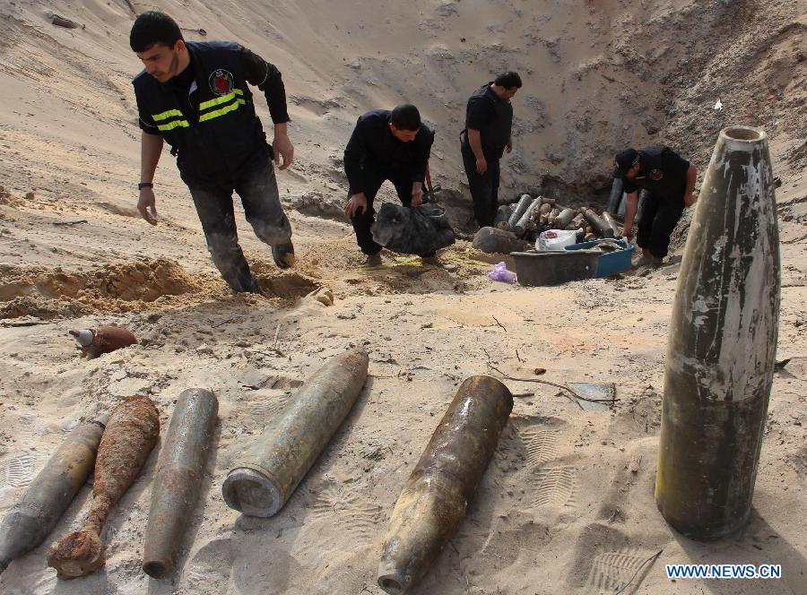Palestinian security members of Hamas put together unexploded Israeli missiles that landed on Gaza on Nov. 2012 before a demolishment event in the southern Gaza Strip city of Rafah on Feb. 25, 2013. (Xinhua/Khaled Omar) 