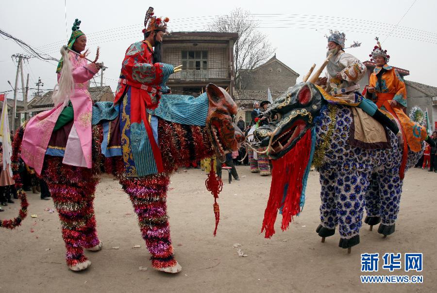 Villagers perform "stilts of beasts" in Jishan county in Shanxi on Feb. 18, 2013. "Stilts of beasts" is a rare folk art performance, which was listed on national intangible cultural heritage protection list on 2006. (Xinhua/Xue Jun)