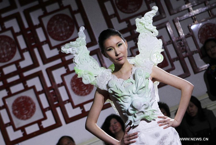 A model displays a creation by Chinese designer Xu Ming at Chinese Cultural Center in Paris, France, Feb. 25, 2013. (Xinhua/Gao Jing)