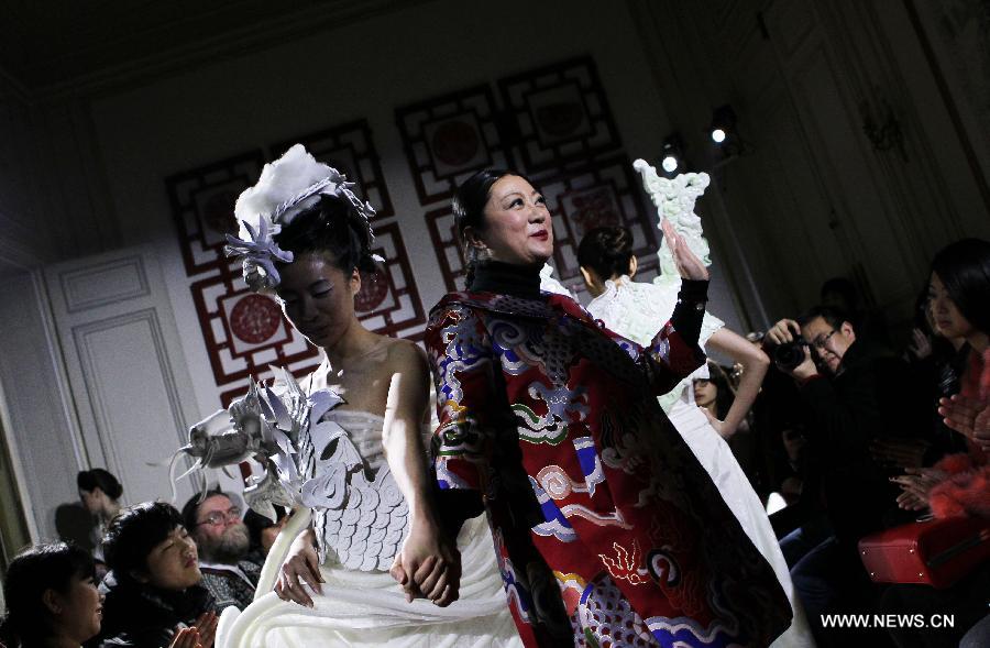 Chinese designer Xu Ming appears at the end of her fashion show at Chinese Cultural Center in Paris, France, Feb. 25, 2013. (Xinhua/Gao Jing)