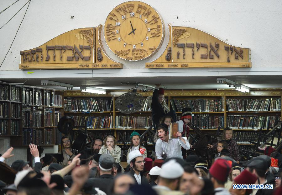 Ultra-Othordox Jews dance in a synagogue to celebrate Purim festival, a Jewish colorful and popular holiday, in Jerusalem, on Feb. 25, 2013. In Jerusalem, Purim was celebrated from sunset on Sunday, Feb. 24, until sunset on Monday, Feb. 25, one day later than it is in the rest of the world. (Xinhua/Yin Dongxun) 