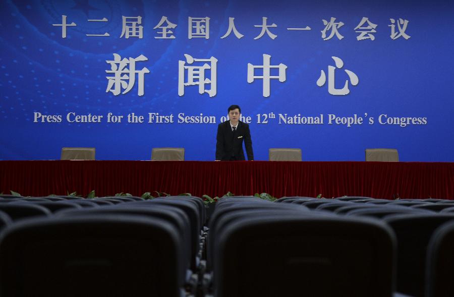 A staff member examines a press room of the press center for the 2013 sessions of the National People's Congress (NPC) and the Chinese People's Political Consultative Conference (CPPCC) in Beijing, capital of China, Feb. 26, 2013. The upcoming annual sessions of the NPC, China's top legislature, and the CPPCC, the country's top political advisory body, launched a press center Tuesday in the Media Center Hotel in downtown Beijing. (Xinhua/Jin Liangkuai) 