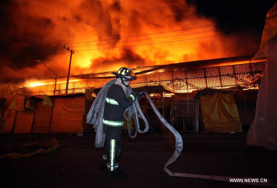 A member of Fire Department works to extinguish a fire in the Merced's Market, in Mexico City, capital of Mexico, on Feb. 27, 2013. The fire that broke out this morning in the Merced's Market was already controlled by the Fire Department with no victims being registered, official sources said. (Xinhua/Angel Vargas) 