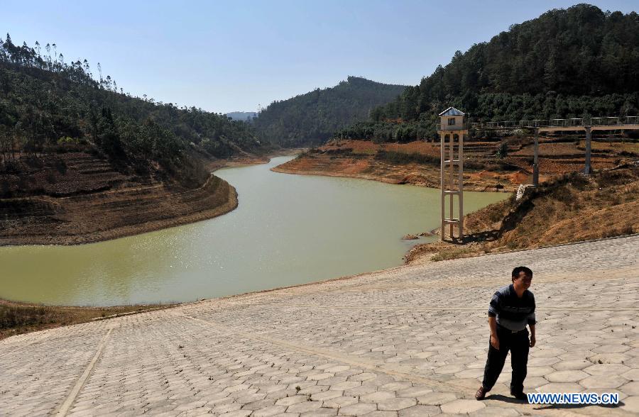 A man walks on the bank of a drought-plagued reservoir in Shilin County of southwest China's Yunnan Province, Feb. 27, 2013. About 600,000 people are facing shortage of drinking water amid severe drought that hit southwest China's Yunnan Province for the fourth straight year, and the current drought has affected 5.11 million mu of cropland in the province China's drought relief authority said Feb. 21, 2013. (Xinhua/Lin Yiguang) 