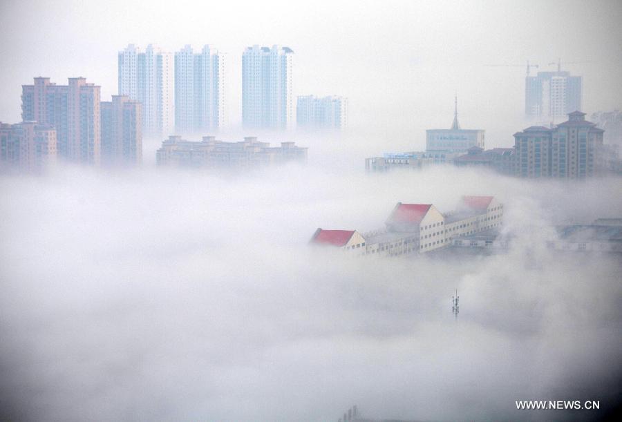 Photo taken on Feb. 27, 2013 shows the fog-shrouded buildings on Binhaizhong Road in Weihai, a coastal city of east China's Shandong Province. The central and eastern parts of China still saw fog and haze on Wednesday. (Xinhua/Yu Qibo)
