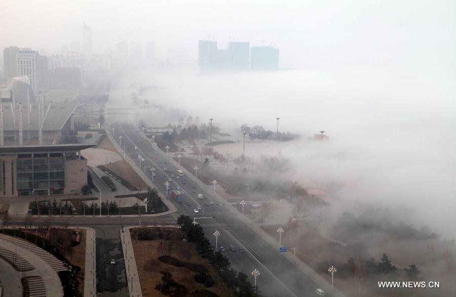 Photo taken on Feb. 27, 2013 shows the scenery of fog-shrouded Weihai, a coastal city of east China's Shandong Province. The central and eastern parts of China still saw fog and haze on Wednesday. (Xinhua/Yu Qibo)