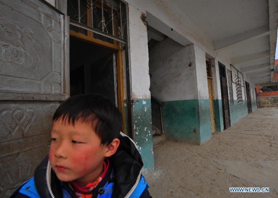 A student stands by the scene of a stampede accident at the Qinji Elementary School in Xueji County of Xiangyang, central China's Hubei Province, Feb. 27, 2013. Four students were killed in a stampede accident here on Wednesday morning. Relevant departments of Xiangyang have rushed to the scene to carry out rescue efforts, and the injured have been sent to hospital for treatment. The cause of the accident is under investigation. (Xinhua/Xiao Yijiu)