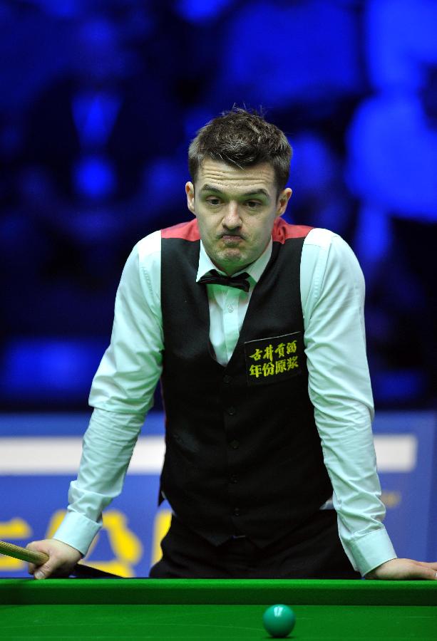 Michael Holt of England reacts during the first round match against Ding Junhui of China at the Haikou World Open snooker tournament in Haikou, capital of south China's Hainan Province, Feb. 27, 2013. Ding Junhui won 5-4. (Xinhua/Guo Cheng)