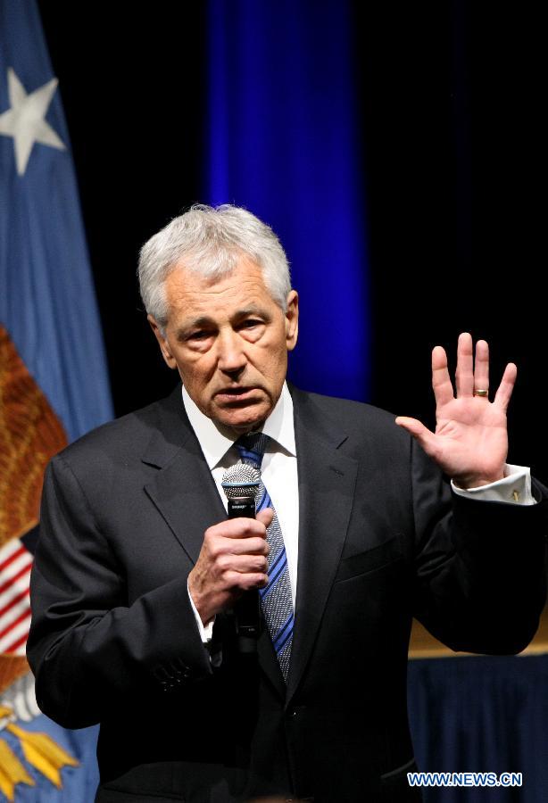 U.S. Defense Secretary Chuck Hagel speaks to Defense Department employees at the staff meeting after he was sworn in as the new Pentagon chief at the Pentagon, Feb. 27, 2013. In remarks to Defense Department employees, he deplored the uncertainty brought about by impending automatic cuts to the defense budget, and promised to do everything in his power to meet those challenges. (Xinhua/Fang Zhe)