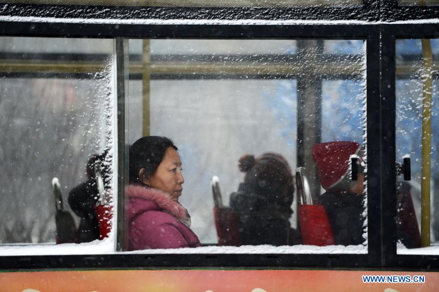 The windows of a public buses are covered with snow in Harbin, capital of northeast China's Heilongjiang Province, Feb. 28, 2013. Most areas of Heilongjiang witnessed snowfall on Thursday. (Xinhua/Wang Kai) 