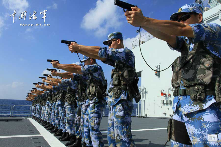 The 14th escort taskforce under the Navy of the Chinese People's Liberation Army (PLA) organizes its special operation members from the Harbin guided missile destroyer, the Mianyang guided missile frigate and the Weishan Lake comprehensive supply ship to conduct a precision shooting training with pistol and rifle on February 27, 2013. (navy.81.cn/Qin Chuan, Li Ding, Yang Qinghai)
