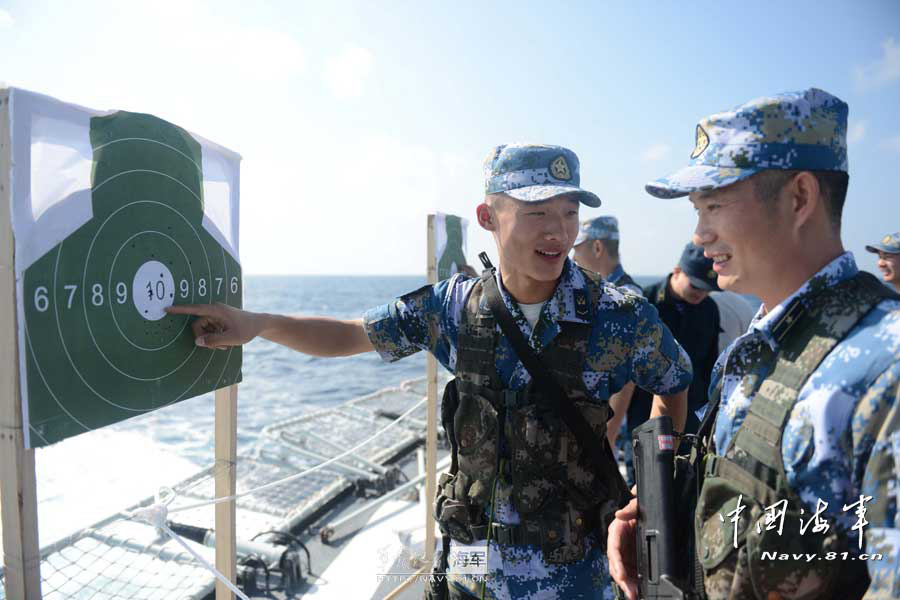 The 14th escort taskforce under the Navy of the Chinese People's Liberation Army (PLA) organizes its special operation members from the Harbin guided missile destroyer, the Mianyang guided missile frigate and the Weishan Lake comprehensive supply ship to conduct a precision shooting training with pistol and rifle on February 27, 2013. (navy.81.cn/Qin Chuan, Li Ding, Yang Qinghai)