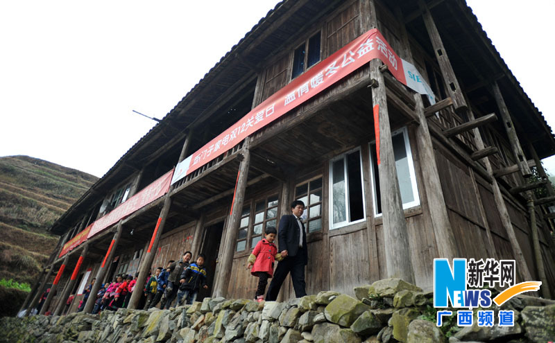 Yu Qigui leading students walks past a classroom on Feb. 26, 2013. (Photo/Xinhua)